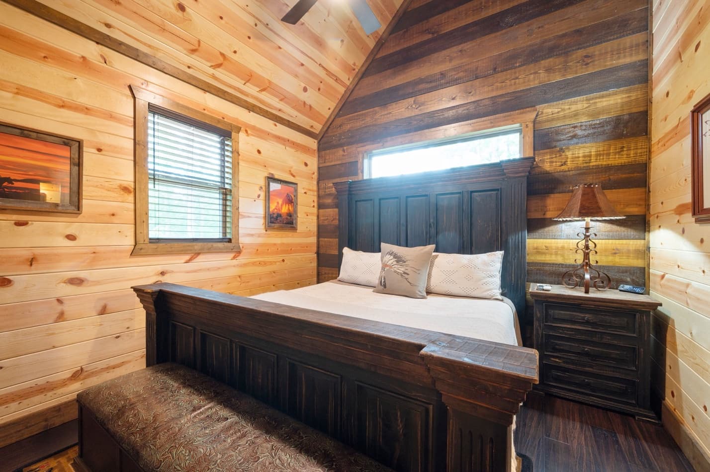 King bedroom with a bench, side table, and lamp