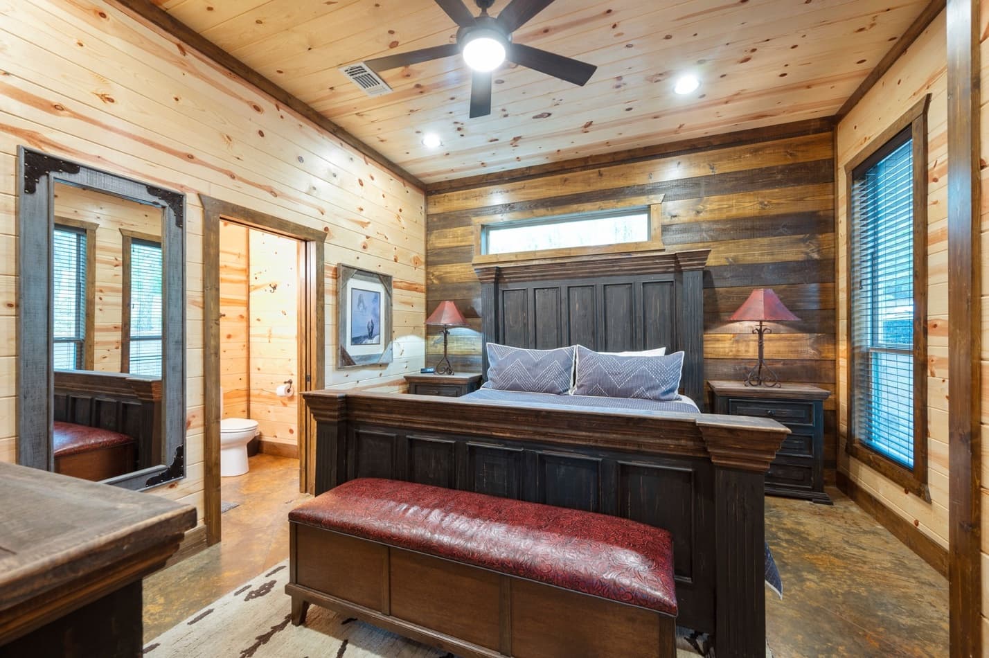 King bedroom with bench, side tables, and lamps