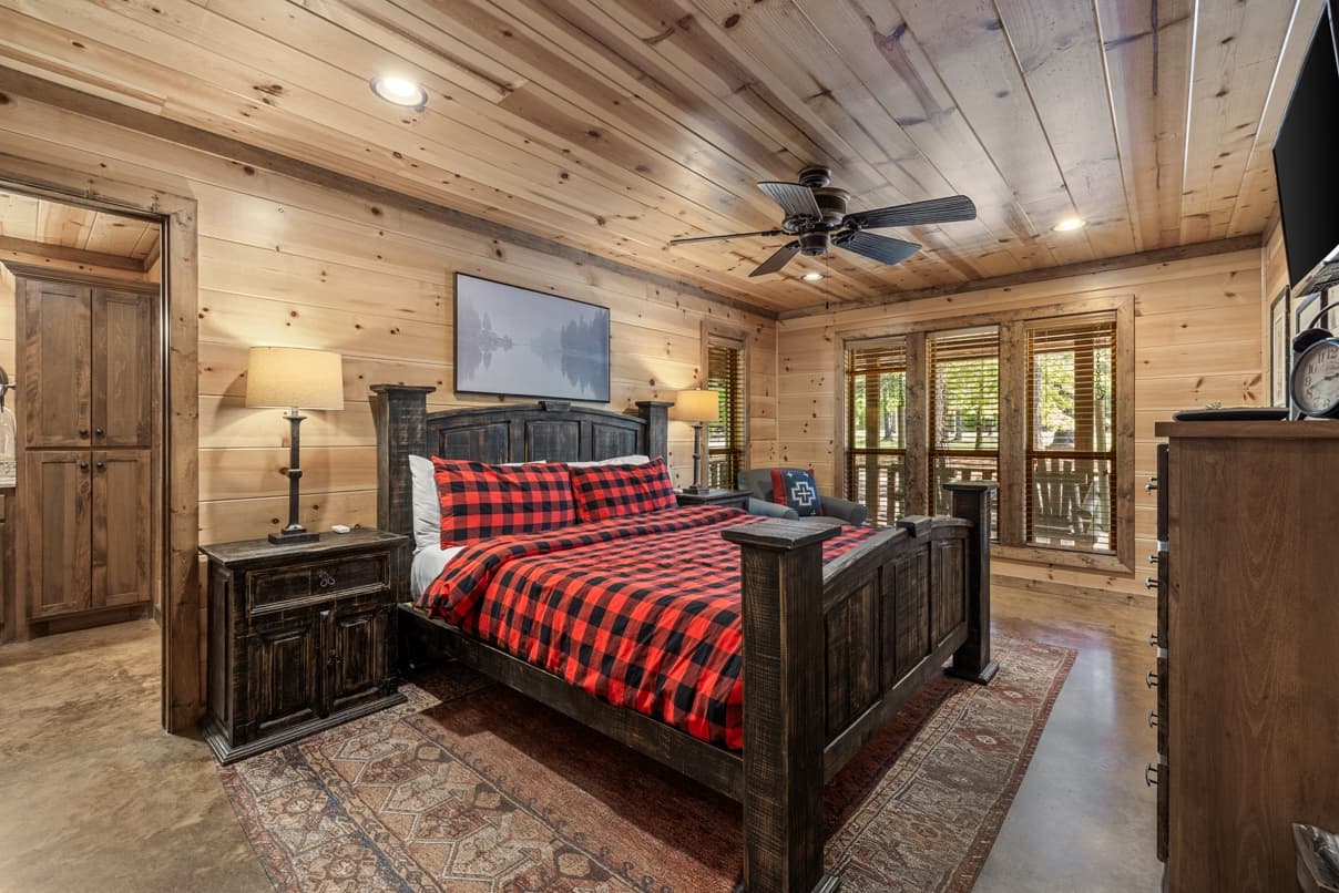 King bedroom, side tables, lamps, a dresser, and TV