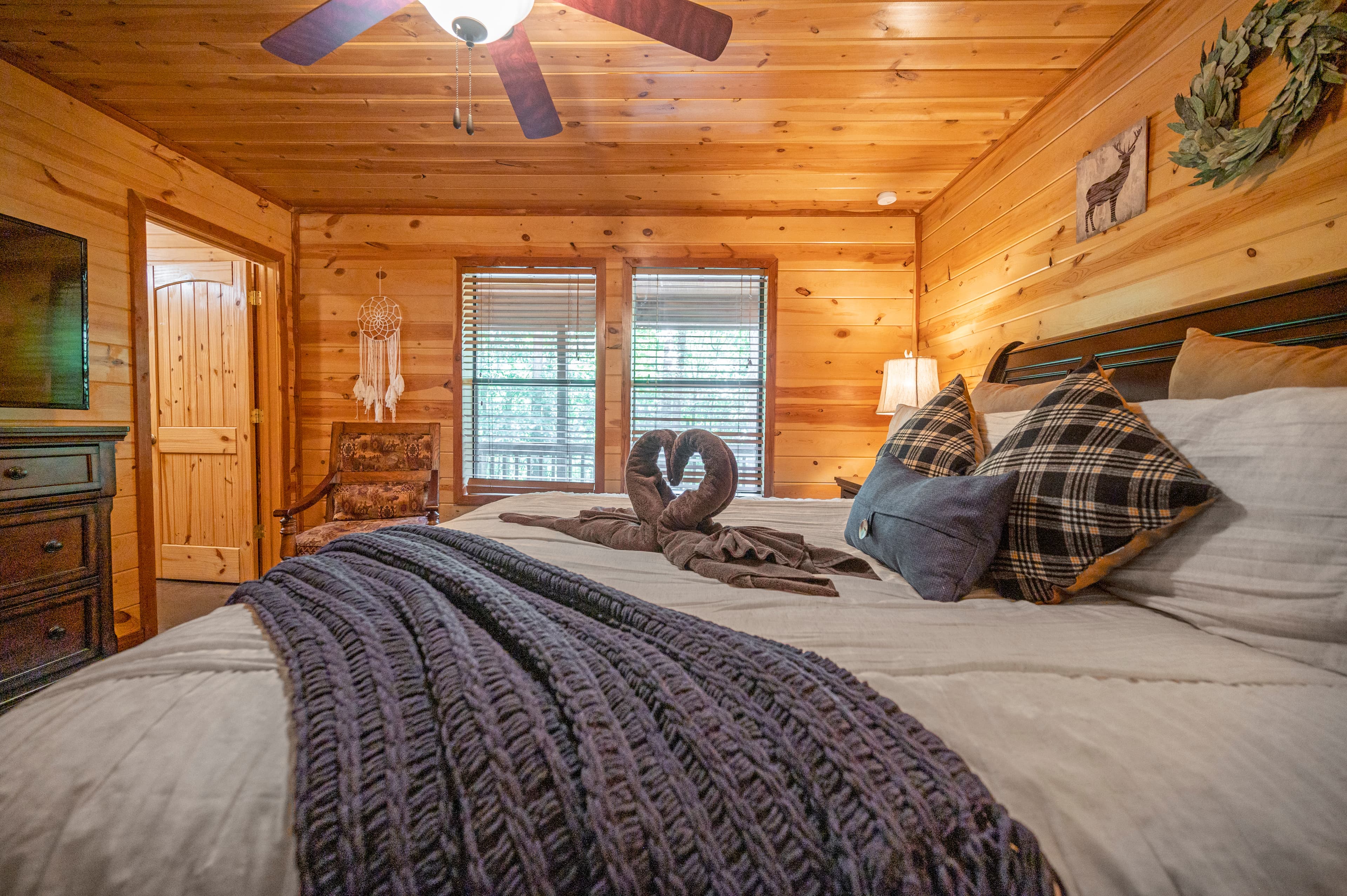 King bedroom with TV and dresser, side table, lamp