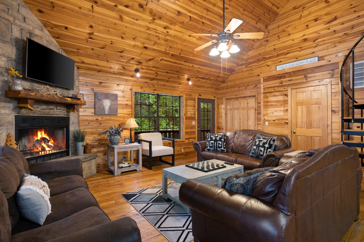 Open living room with 3 couches and fireplace