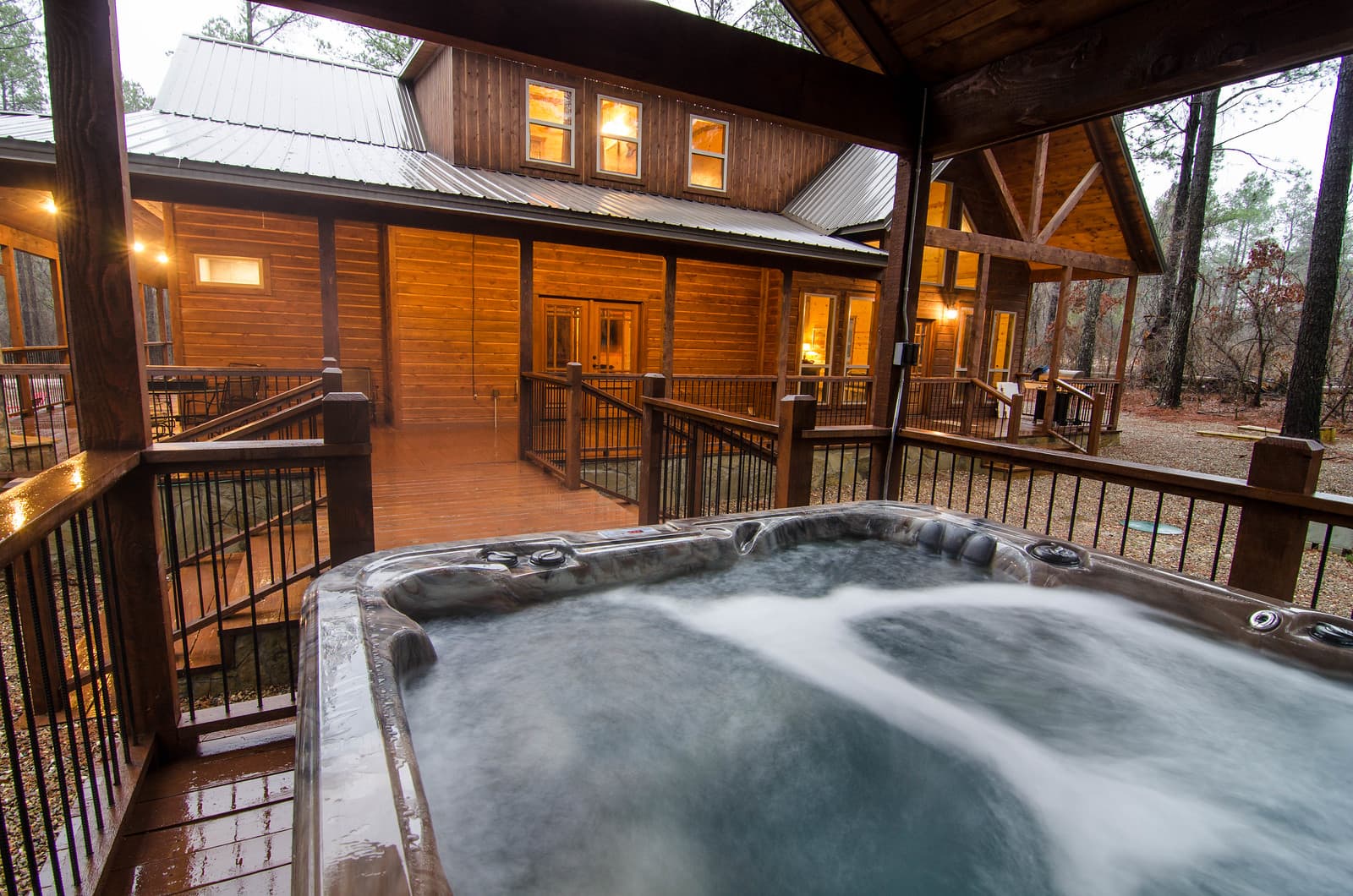 hot tub on covered wooden extended deck