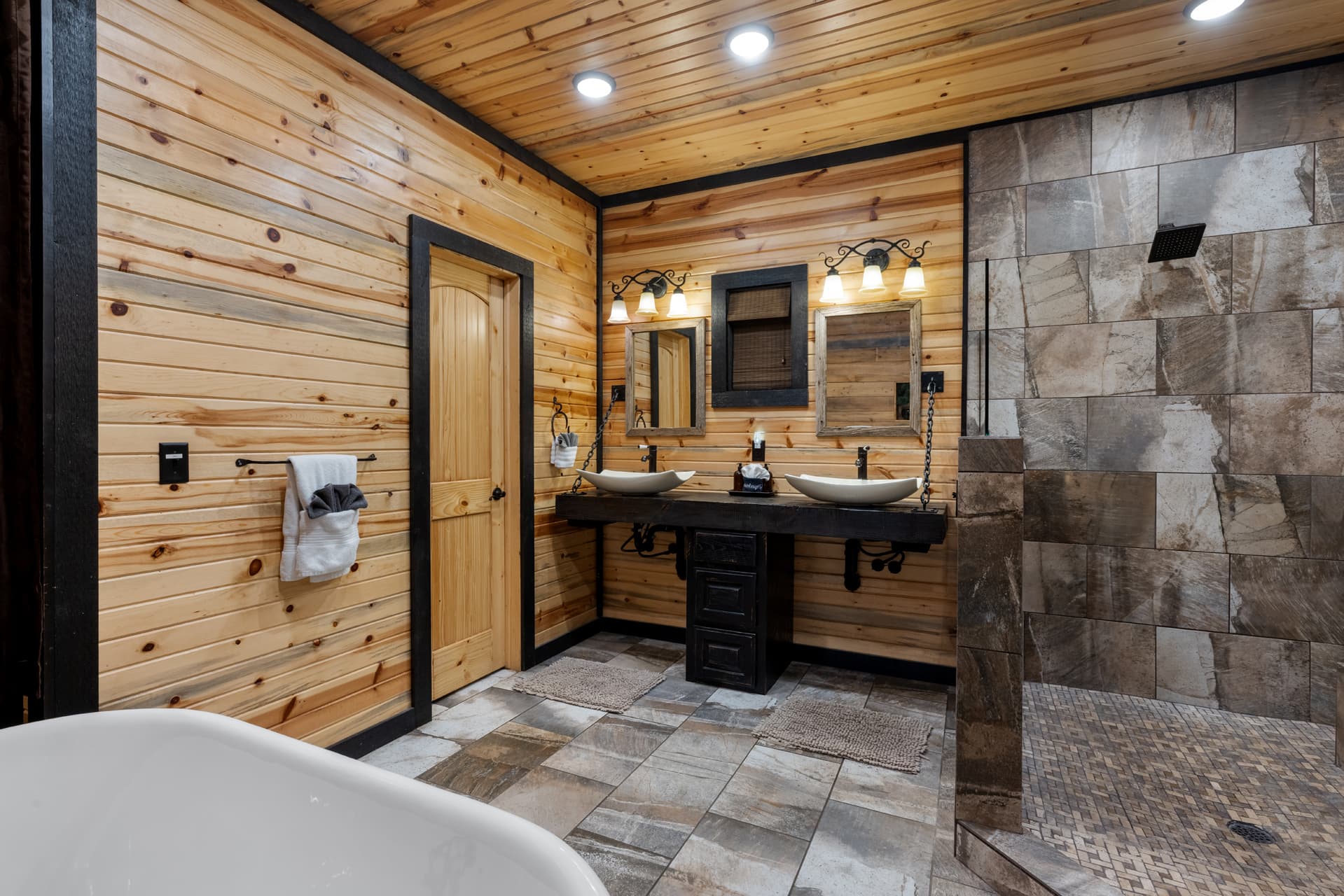 Bathroom with tub, shower, and sinks