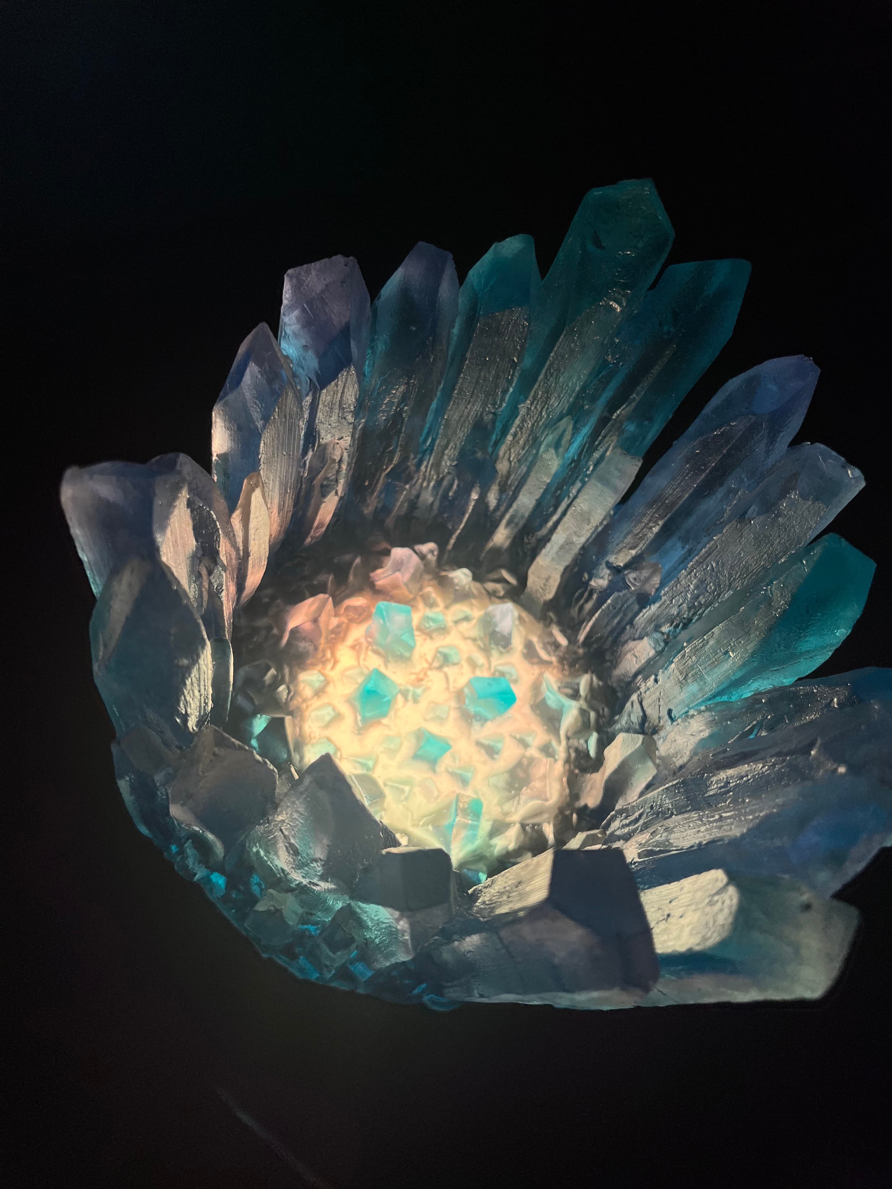 A glowing crystal formation with sharp edges in varying shades of blue and transparent hues.