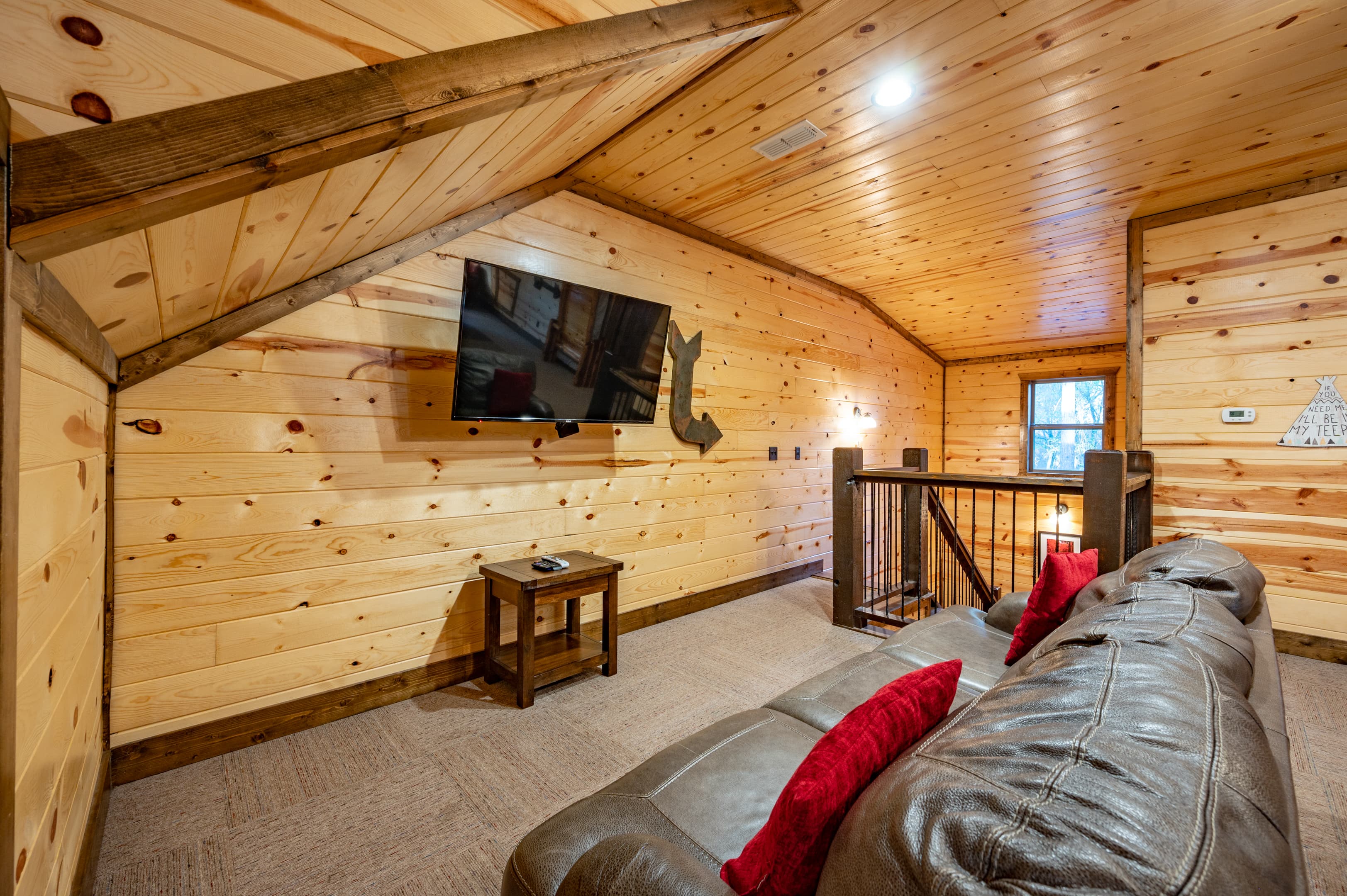 Couch and TV in pool table room