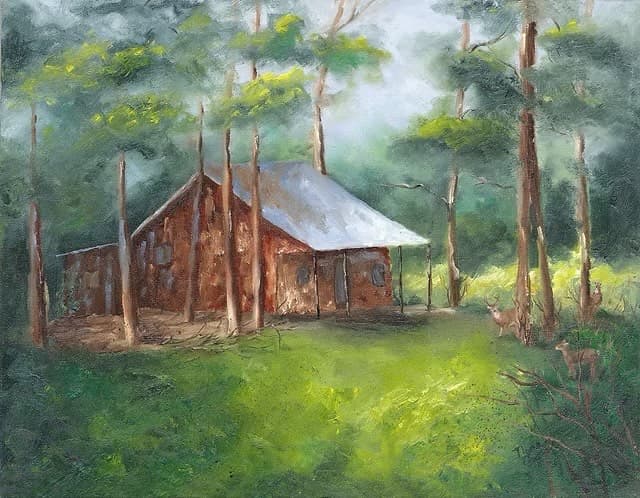 A rustic cabin surrounded by tall trees and two deer grazing in a lush green clearing.