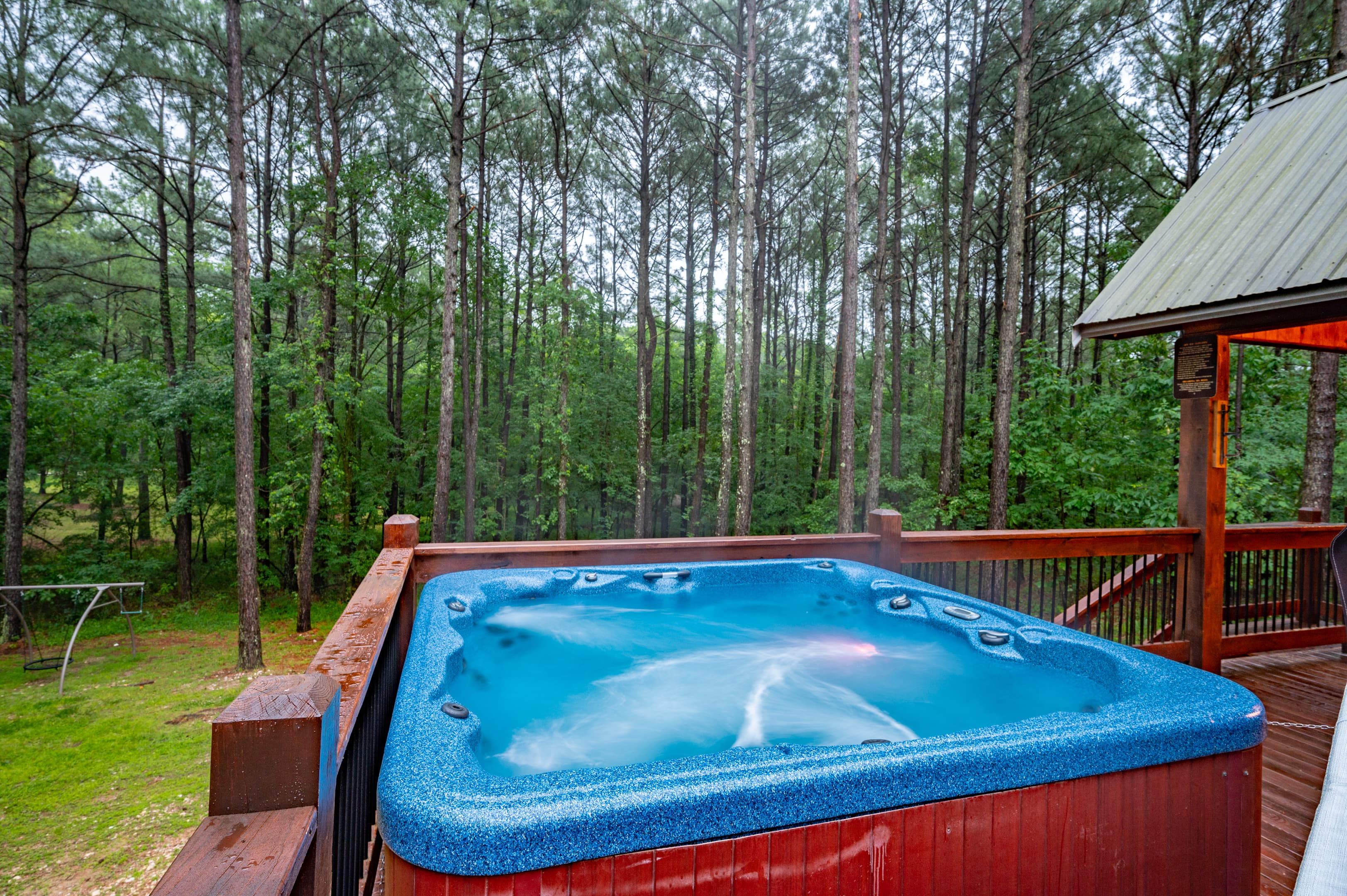 hot tub on uncovered deck and forest view