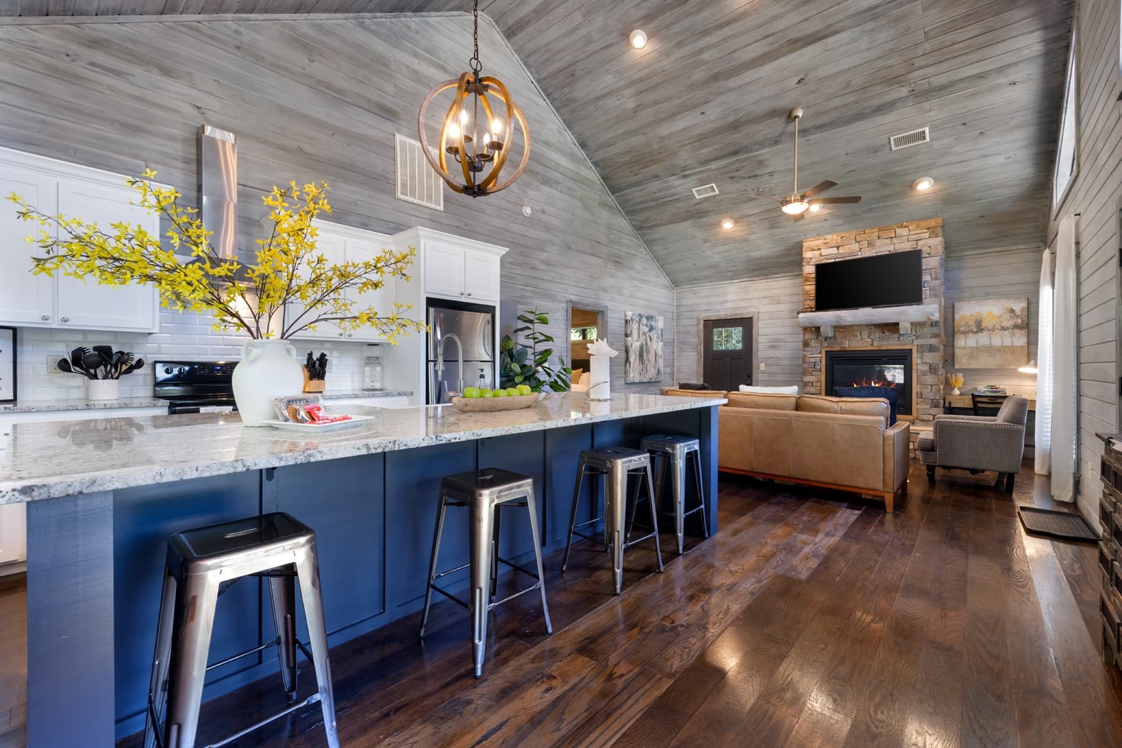 Open modern kitchen with large island and 4 stools