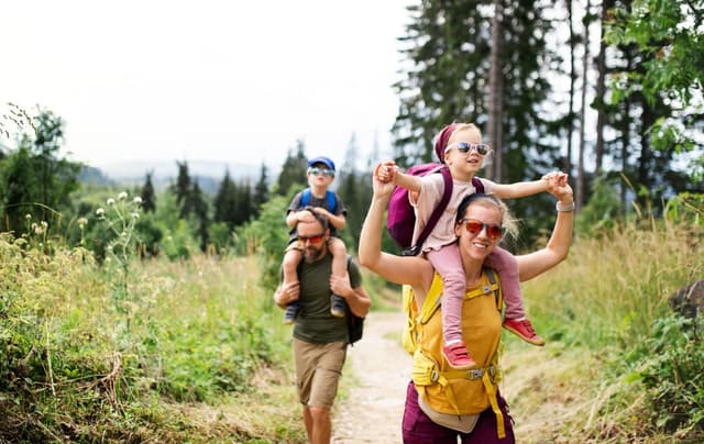 A photo of a family hiking in Beavers Bend State Park, one of the fantastic activities available.