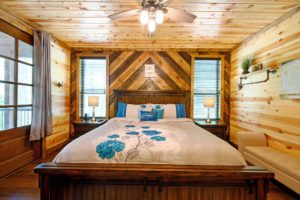 The cozy bedroom of a cabin rental, one of the best places to stay in Broken Bow, OK.