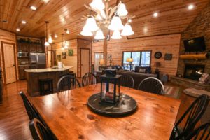 The dining room area of Broken Bow cabin rental to relax in while looking up what to do in town.