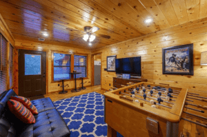 The game room of a Hochatown cabin rental close to a new Oklahoma art gallery.