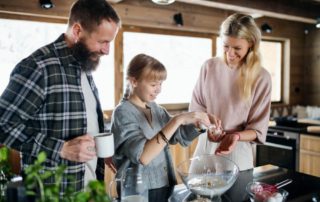 A family cooking winter recipes in their Hochatown cabin rental.