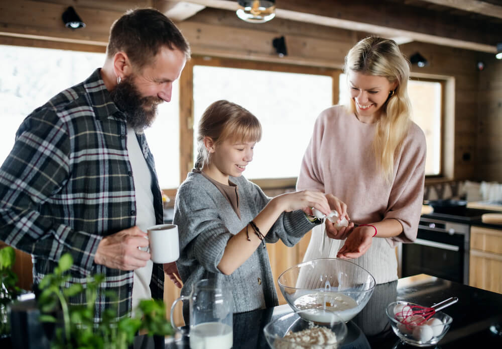 A family cooking winter recipes in their Hochatown cabin rental.