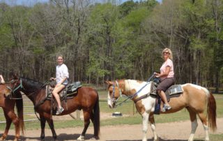 A group of people horseback riding, one of the best activities in Hochatown.